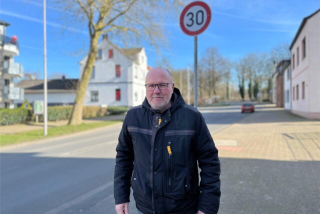 Dietmar Grundmann steht vor einem Tempo-30-Schild an der Hafenstraße.