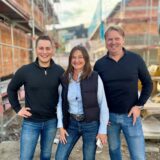 Leonard Sonntag, Anke Langkamp und Thomas Langkamp stehen am Tag des Richtfests auf der Baustelle.