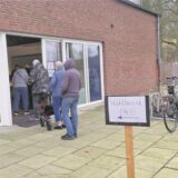 Einige Männer und Frauen stehen im Eingangsbereich der Freizeit- und Begegnungsstätte Westerholt und warten darauf, bei der Bundestagswahl 2025 in Herten ihre Stimme abzugeben.
