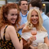Zwei Frauen lächeln auf dem Feierabendmarkt in Dortmund mit einem Getränk in der Hand in die Kamera.