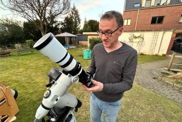 Astro-Fotograf Georg Röer mit seinem Linsenteleskop im Garten seines Hauses in Haltern am See.