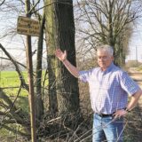 Ein Mann weist an einer Allee auf das Schild Privateigentum hin.