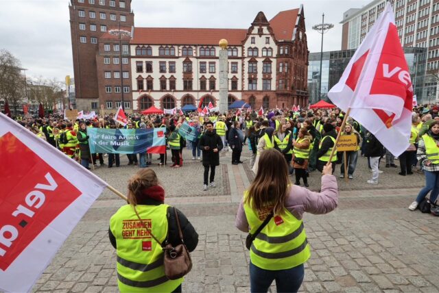 Teilnehmende einer Verdi-Demonstration in Dortmund halten Fahnen in die Höhe. Sie streikten wegen stockender Tarifverhandlungen im öffentlichen Dienst.