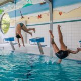 Zwei Jugendliche springen in ein Becken.