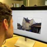 Volontär Moritz Klindworth schaut sich ein Foto von einem Haus an der Lohbuschstraße an.