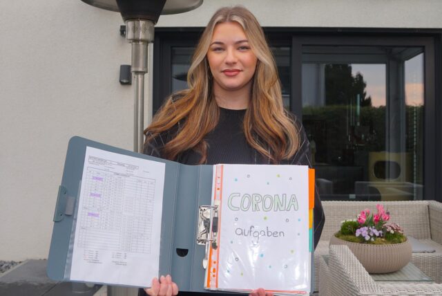 Mia Nachlik (20) steht an einen Baum gelehnt und lächelt in die Kamera.