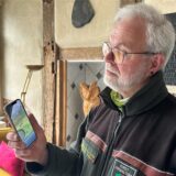 Wolfsberater Winfried Hardes schaut sich das Video mit dem vermeintlichen Wolf aus dem Dortmunder Süden auf dem Handy an.