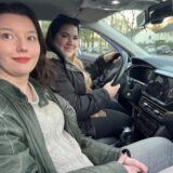 Zwei junge Frauen sitzen in einem Pkw.