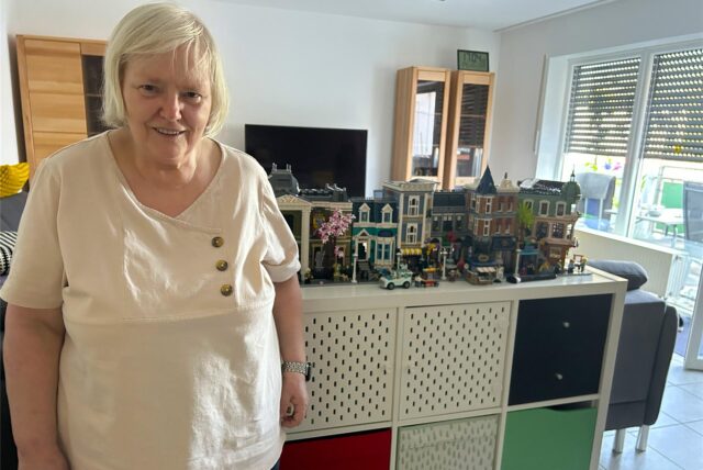 Monika Janzen steht vor ihren Lego-Häusern.