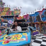 Eine Frau auf einer Kirmes.