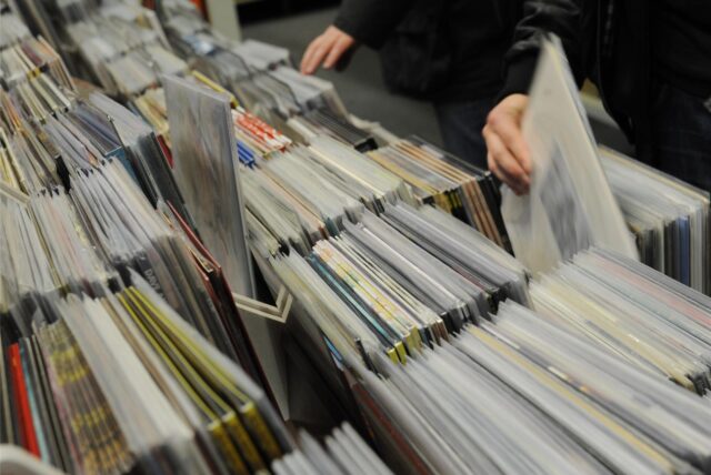 Menschen stöbern an Ständen voller Schallplatten