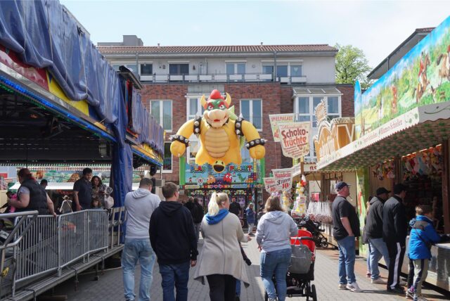 Menschen laufen über die Osterkirmes in Hüls.