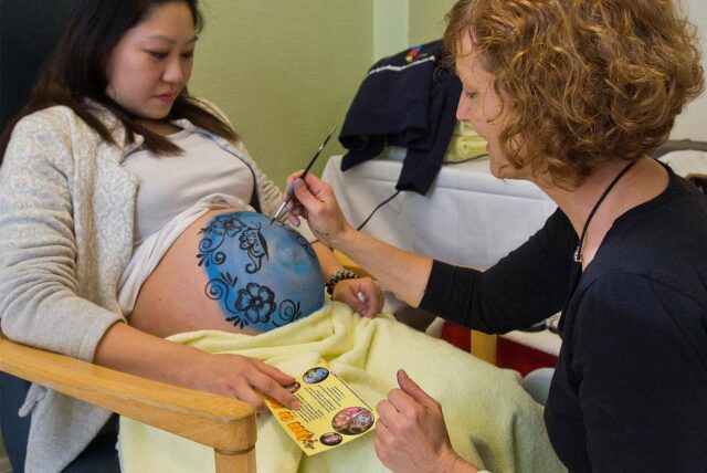 Die werdende Mutter Claire Wong ließ sich in ihrer Schwangerschaft von Barbara Massmann den „Babybauch“ bemalen. So ging es zu bei den Tagen der offenen Tür in der der „Wiege“. Steht die Einrichtung nun auch auf dem Spiel?