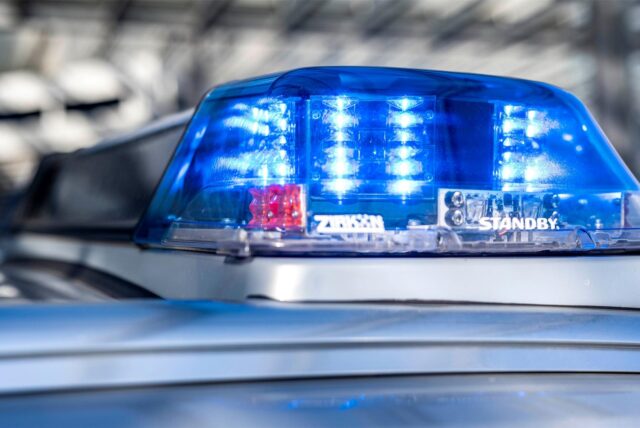 Das Blaulicht an einem Polizeiwagen ist eingeschaltet.