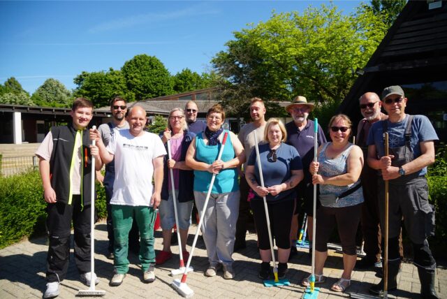 Gruppenbild der Helfer im Bürgerbad mit Wischern in der Hand.