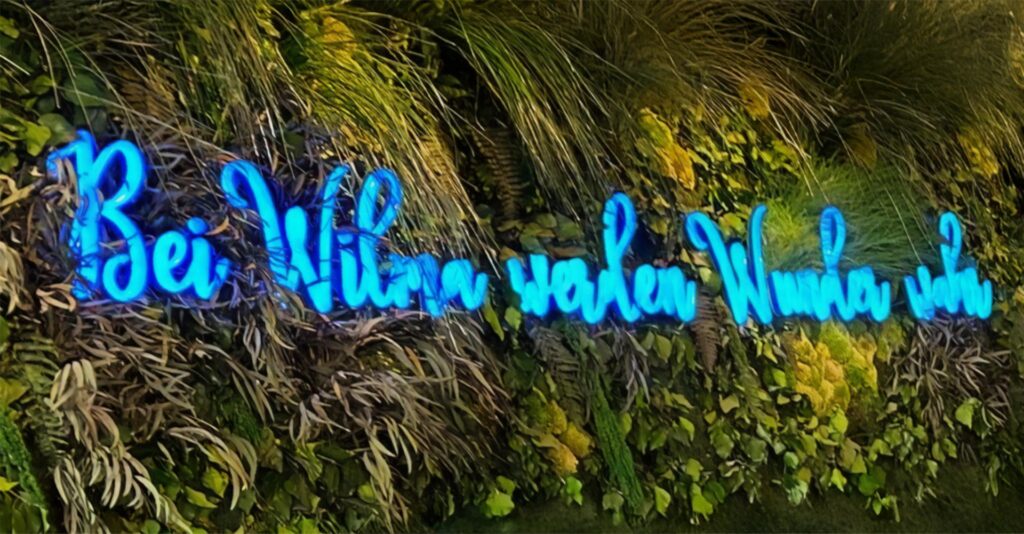 Grüne Wand in Wilma Wunder in Recklinghausen mit blauem Neon-Schriftzug Grüne Wand in Wilma Wunder in Recklinghausen mit blauem Neon-Schriftzug