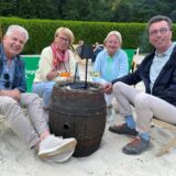 Vier Menschen sitzen in Liegestühlen.