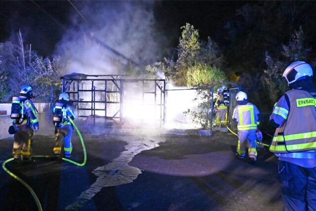 Die Feuerwehr löscht ein brennendes Gartenhaus.