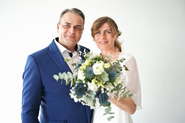 Das Brautpaar Anne und Mark-André Niehöfer mit einem Brautstrauß.