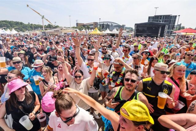 Besucher feiern auf dem Festival «Inselfieber» in Oberhausen. (zu dpa: «Ballermann am Rhein-Herne-Kanal»)