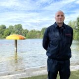 Ein Feuerwehrmann steht vor einem Naturfreibad in Marl.
