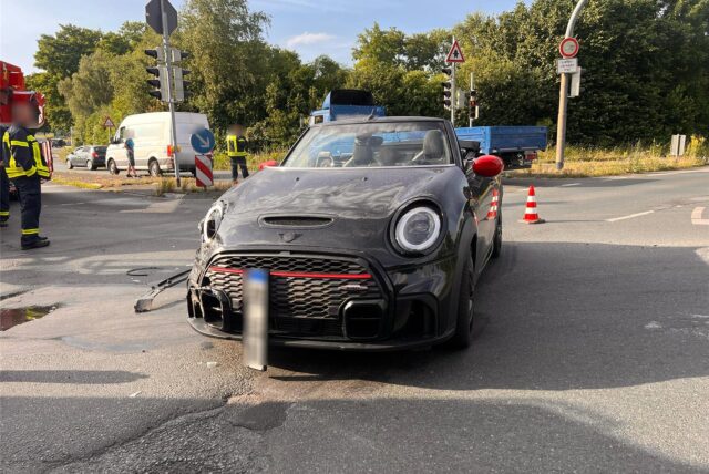 Ein beschädigtes Auto steht auf einer Kreuzung.