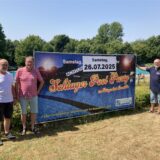 Drei Vereinsmitglieder stellen im Freibad in Marl-Hüls ein Werbeplakat auf.