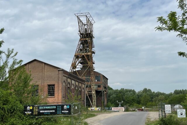 Ein Blick von der Ewaldstraße auf den Eingang zum ehemaligen Zechengelände in Oer-Erkenschwick. Im Hintergrund steht der Förderturm.